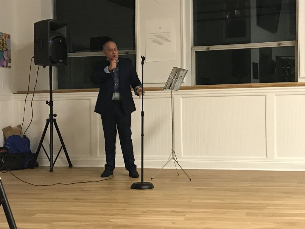 Black suit singing with eyes closed