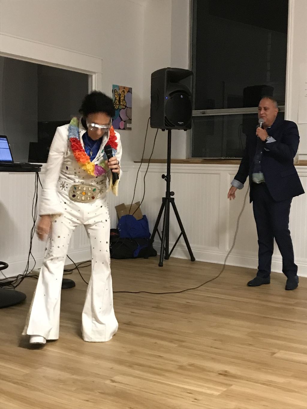 Dressed up as Elvis and man in black suit singing