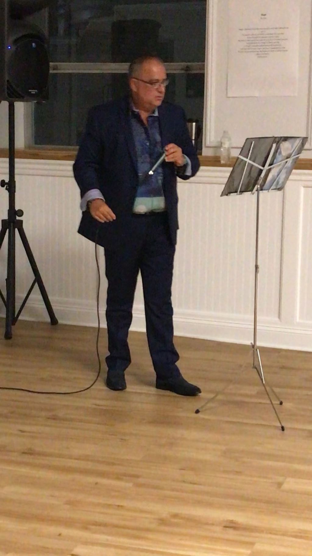 black suit holding microphone