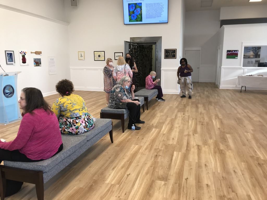 Sitting on benches looking at paintings