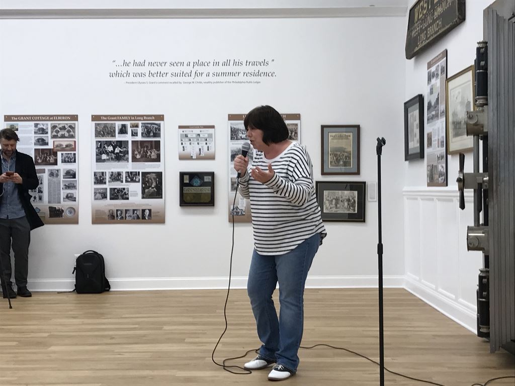 Comedy Night - Dawn holding hand to side