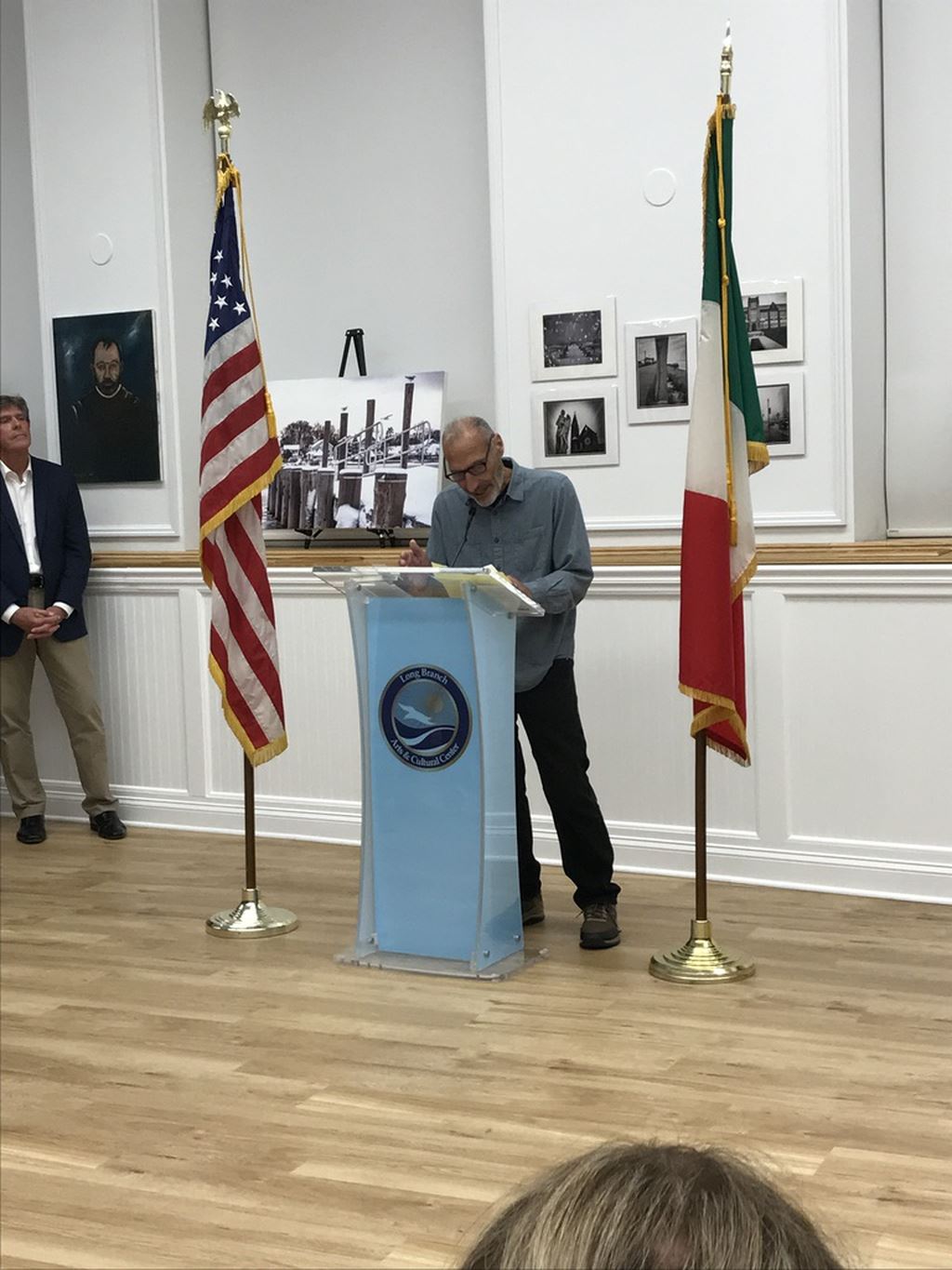 Man with glass at podium close-up