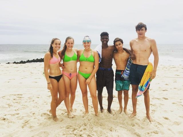 6 Junior lifeguards standing on beach